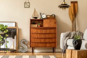 Stylish and vintage interior design of open space with wooden retro cabinet.