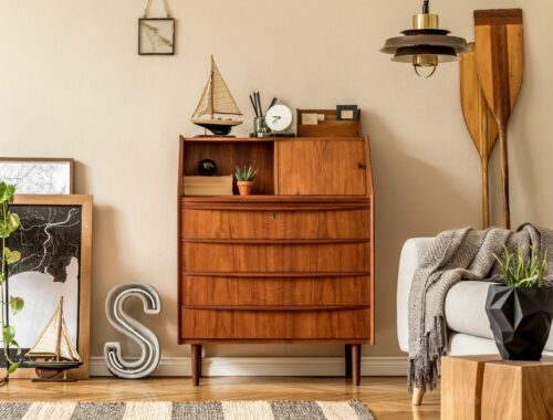 Stylish and vintage interior design of open space with wooden retro cabinet.