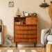 Stylish and vintage interior design of open space with wooden retro cabinet.